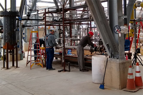 Three people installing solar power plant infrastructure