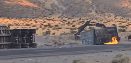 A truck with a crane in the middle of a desertDescription automatically generated